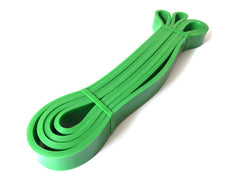 Green latex loop resistance band with two end loops and stacked band length.