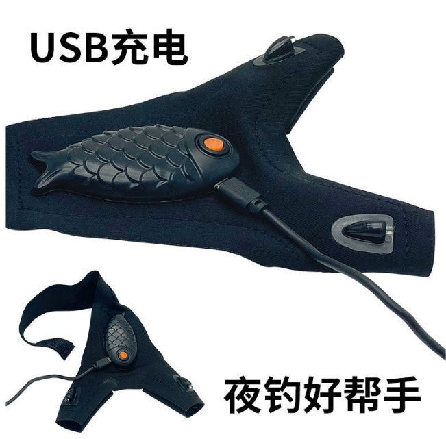 Black LED flashlight glove with fish-scale palm, orange control, and USB cable