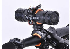 Black bicycle light mounting bracket on handlebar with orange inner ring accents