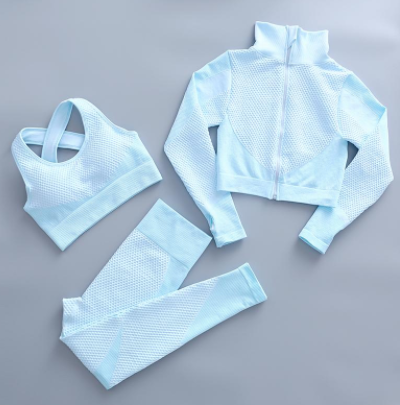 Women's light blue fitness set: zip mock-neck jacket, sports bra, high-waist leggings.
