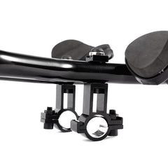 Black aero handlebar extension rest clamp with central bolt and two comfort pads