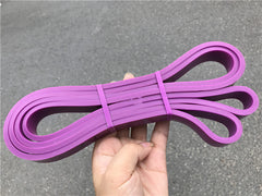 Pink latex loop resistance bands with two end loops and tied center wrap.