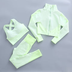 Women's light green fitness set with zip mock-neck jacket, sports bra, high-waist tights.