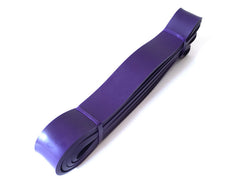 Purple latex loop resistance band with two end loops and stacked band length.