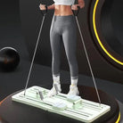 Woman using compact Pilates sliding board with rope handles while standing