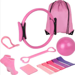 Pink pilates workout set with resistance ring, bands, yoga ball, and accessory pouch