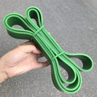 Bright green latex loop resistance bands with two end loops and bundled stack.