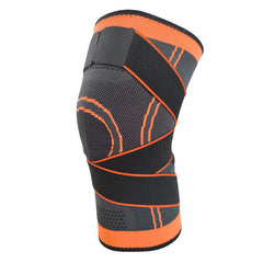 Black knee pad with orange trim, curved padded panels and elastic compression band
