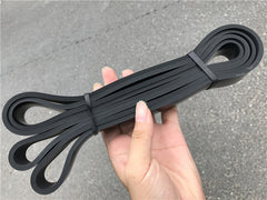 Black latex loop resistance bands with two end loops and tied center wrap.