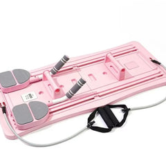 Pink compact Pilates sliding board with gray foot pads and black strap attachments